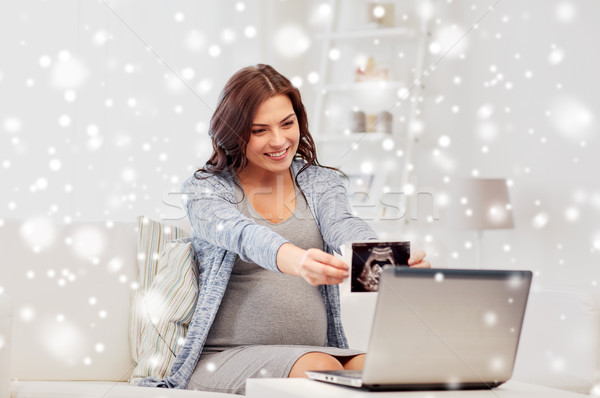 pregnant woman with ultrasound image and laptop Stock photo © dolgachov