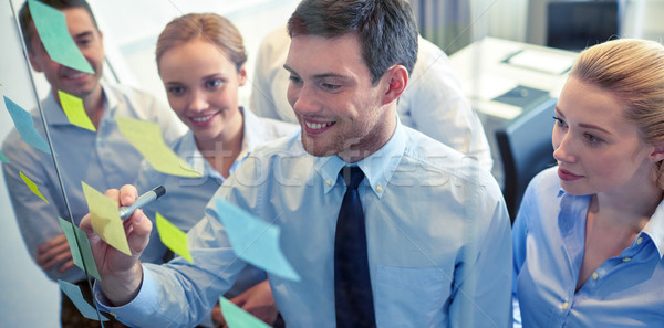 Stock photo: smiling business people with marker and stickers