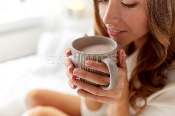 close up of happy woman with cocoa cup at home Stock photo © dolgachov