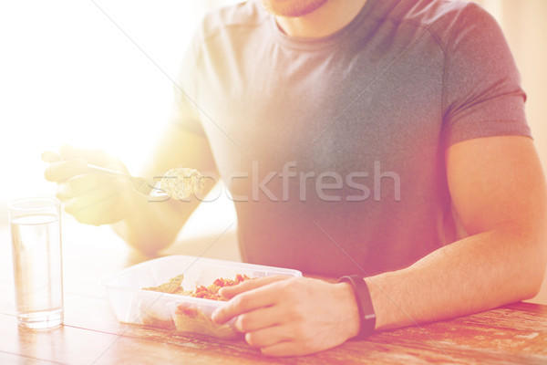 close up of man with fork and water eating food Stock photo © dolgachov