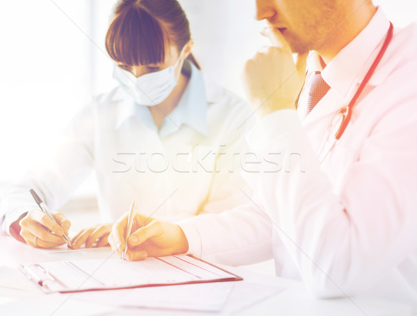 doctor and nurse writing prescription paper Stock photo © dolgachov