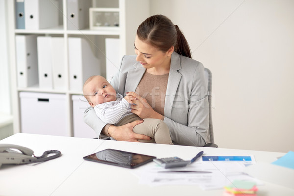 happy businesswoman with baby working at office Stock photo © dolgachov