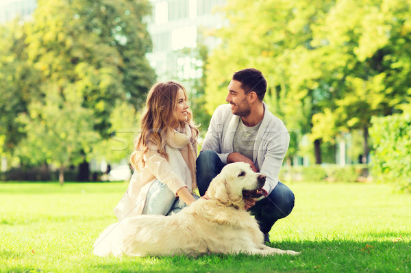 happy couple with labrador dog walking in city Stock photo © dolgachov