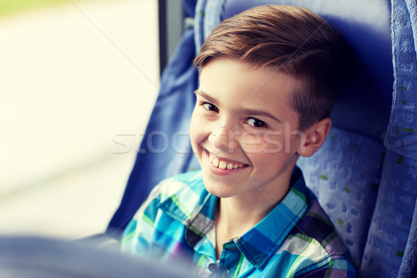 happy boy sitting in travel bus or train Stock photo © dolgachov