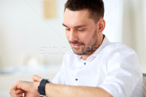 close up of businessman with smartwatch at office Stock photo © dolgachov