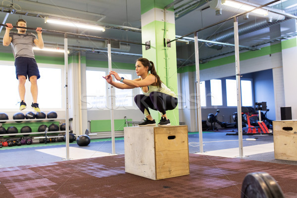 woman and man exercising in gym Stock photo © dolgachov