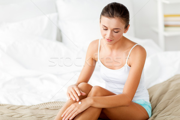 Stock photo: beautiful woman applying hand cream at home