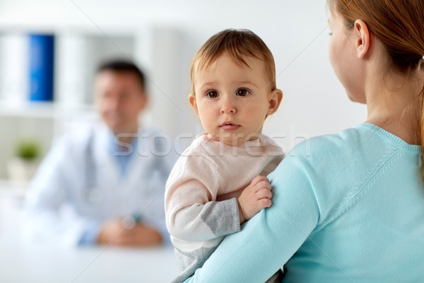 close up of mother with baby and doctor at clinic Stock photo © dolgachov