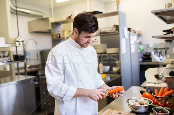 happy male chef cooking food at restaurant kitchen Stock photo © dolgachov