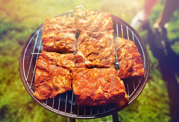 meat cooking on barbecue grill at summer party Stock photo © dolgachov