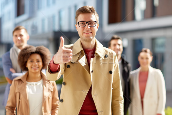 Stock photo: happy smiling man showing thumbs up outdoors