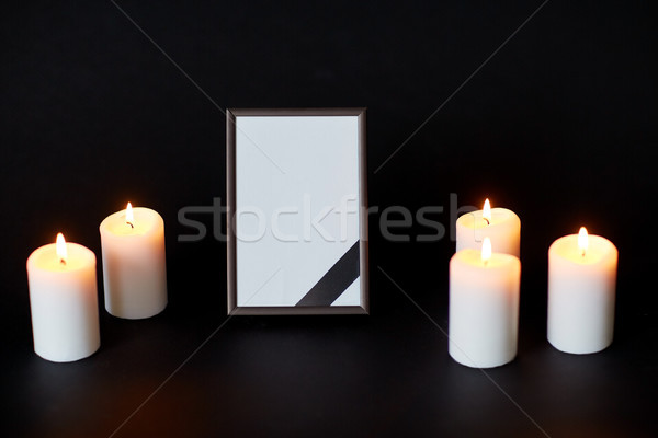 black ribbon on photo frame and candles at funeral Stock photo © dolgachov