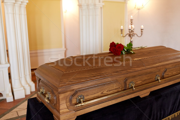 red rose flowers on wooden coffin in church Stock photo © dolgachov