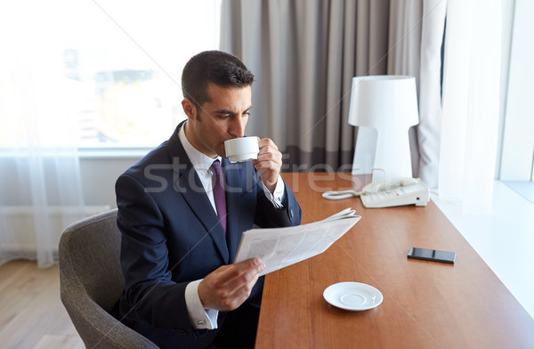 businessman reading newspaper and drinking coffee Stock photo © dolgachov