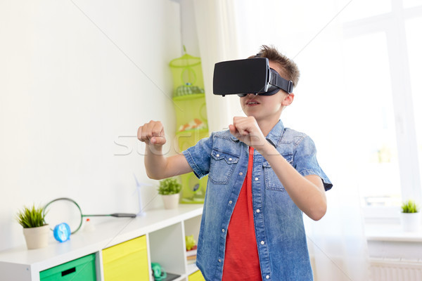 boy in virtual reality headset or 3d glasses Stock photo © dolgachov