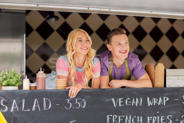 happy young sellers at food truck Stock photo © dolgachov