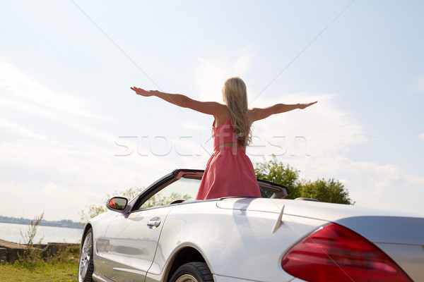 happy young woman in convertible car at seaside Stock photo © dolgachov
