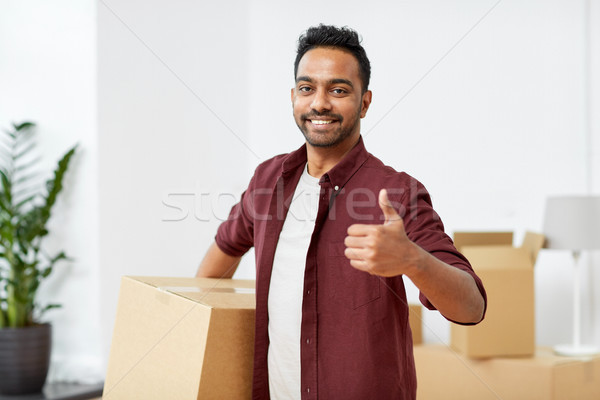 man with box moving to new home showing thumbs up Stock photo © dolgachov