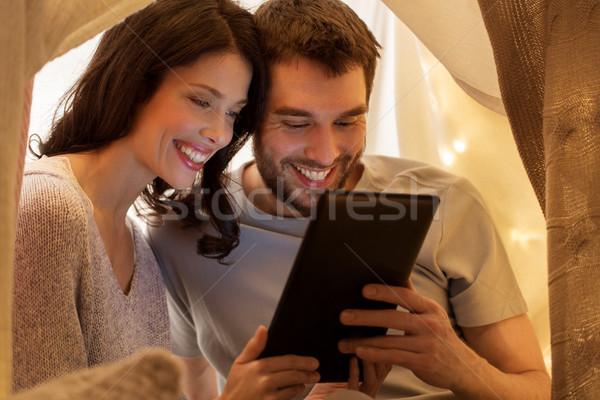 happy couple with tablet pc in kids tent at home Stock photo © dolgachov