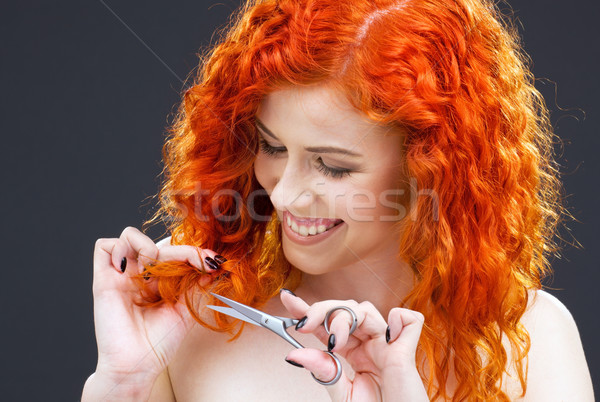 Stock photo: redhead with scissors