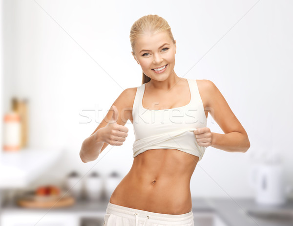 sporty woman showing thumbs up Stock photo © dolgachov