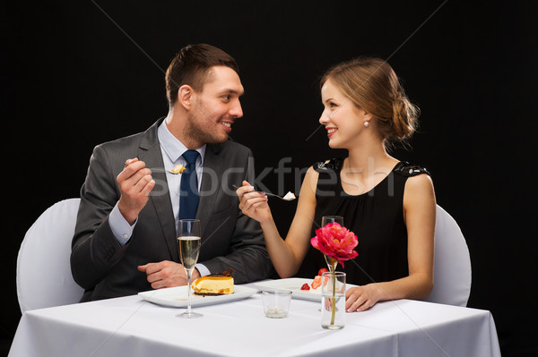 [[stock_photo]]: Souriant · couple · manger · dessert · restaurant · vacances