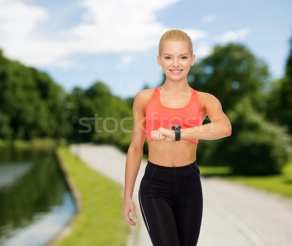 Mujer sonriente ritmo cardíaco supervisar mano fitness tecnología Foto stock © dolgachov