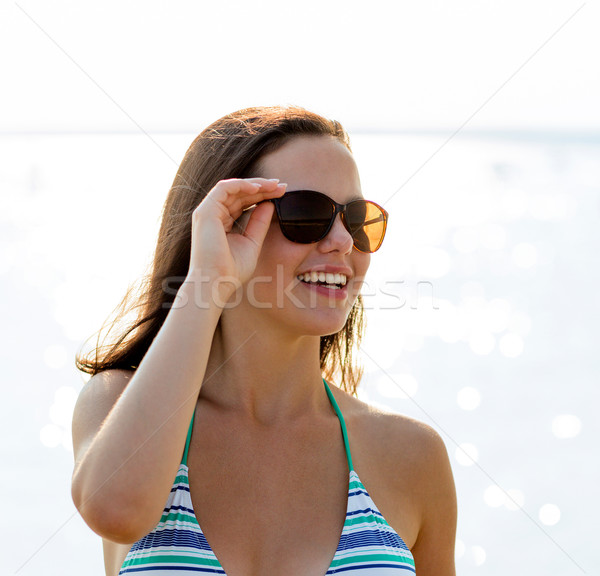 smiling teenage girl in sunglasses Stock photo © dolgachov