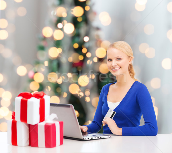 smiling woman with credit card and laptop Stock photo © dolgachov