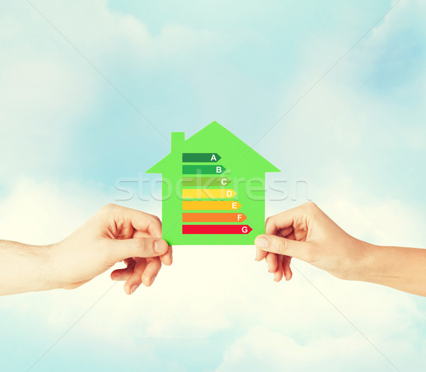 hands holding green paper house Stock photo © dolgachov