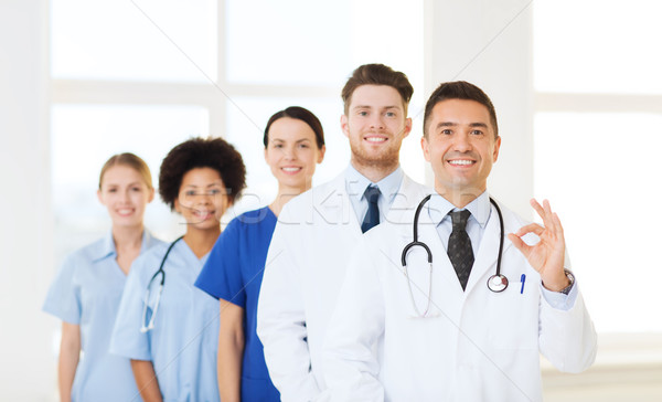 group of happy doctors at hospital Stock photo © dolgachov