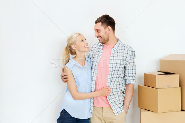 couple with cardboard boxes moving to new home Stock photo © dolgachov