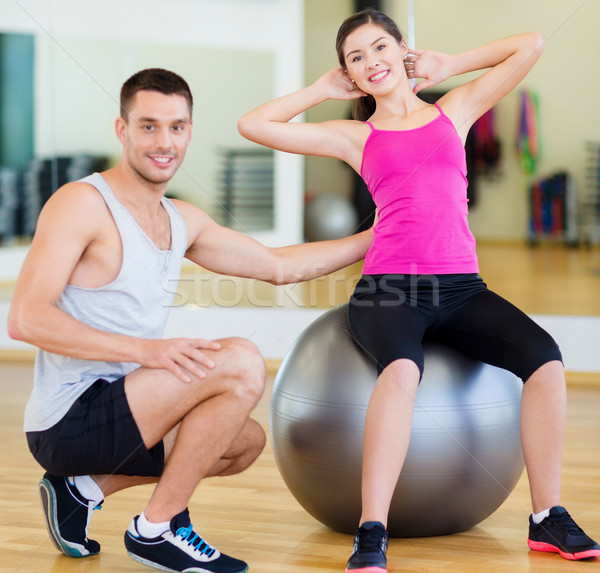 male trainer with woman doing crunches on the ball Stock photo © dolgachov