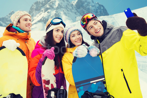 Heureux amis smartphone sports d'hiver loisirs amitié [[stock_photo]] © dolgachov