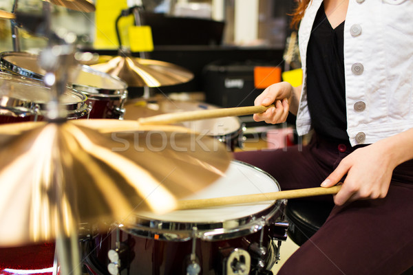 Stock photo: close up of woman playing cymbals at music store