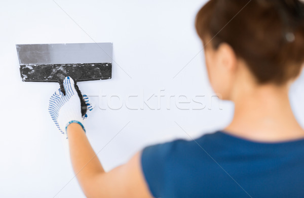woman plastering the wall with trowel Stock photo © dolgachov