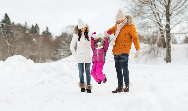 Stock photo: happy family in winter clothes walking outdoors