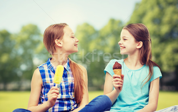 happy little girls eating ice-cream in summer park Stock photo © dolgachov
