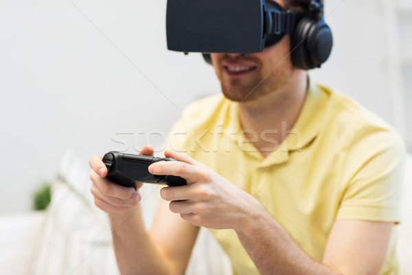 close up of man in virtual reality headset playing Stock photo © dolgachov