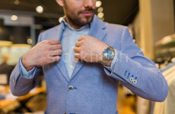 close up of man trying jacket at clothing store Stock photo © dolgachov