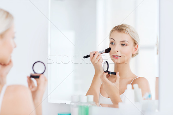 woman with makeup brush and blush at bathroom Stock photo © dolgachov