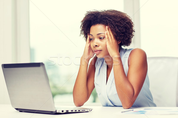 african woman with laptop at office Stock photo © dolgachov