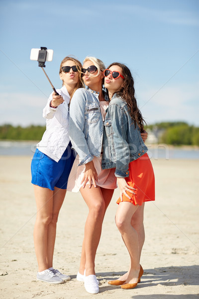 group of smiling women taking selfie on beach Stock photo © dolgachov