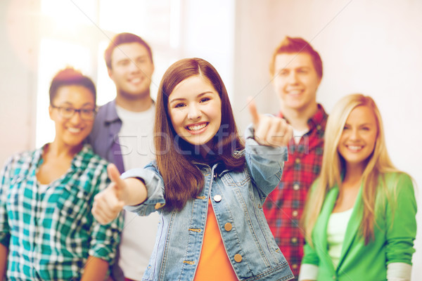 Stock photo: students showing thumbs up at school