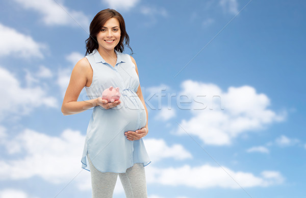happy pregnant woman with piggybank Stock photo © dolgachov