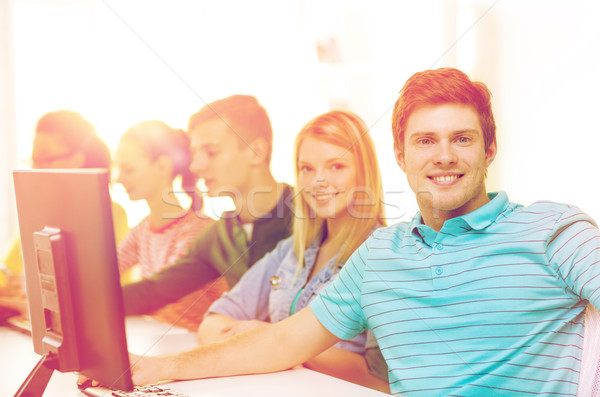 male student with classmates in computer class Stock photo © dolgachov