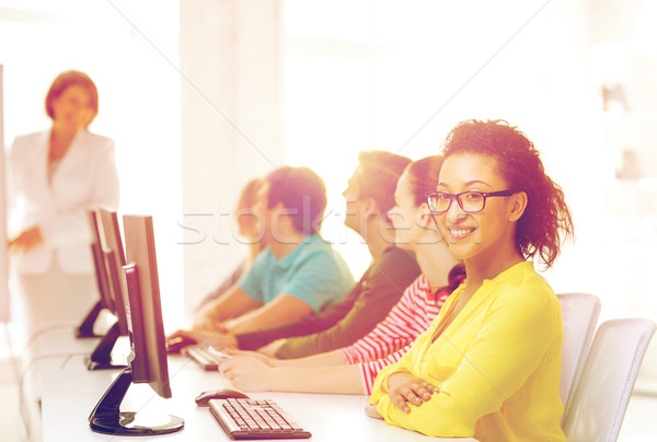 Stock photo: female student with classmates in computer class