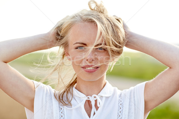 close up of happy young woman in white outdoors Stock photo © dolgachov