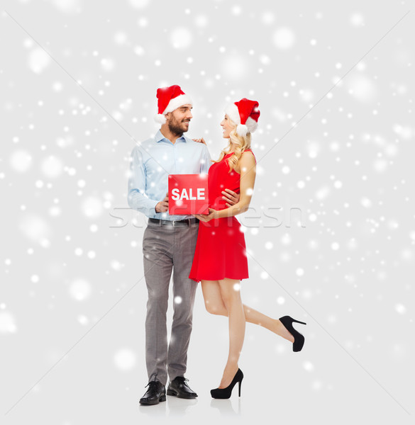 Stock photo: happy couple with red sale sign over snow