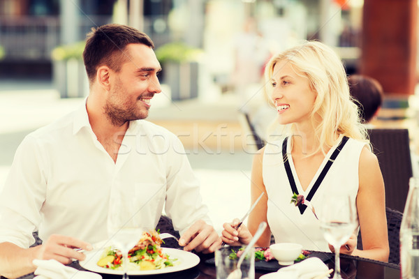 happy couple eating dinner at restaurant terrace Stock photo © dolgachov